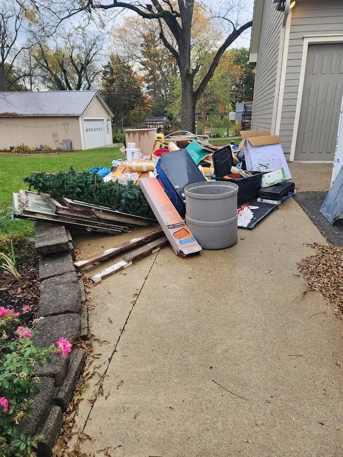 Dumpster being loaded with debris for 3 Yard Dumpster Rental in Grand Rapids